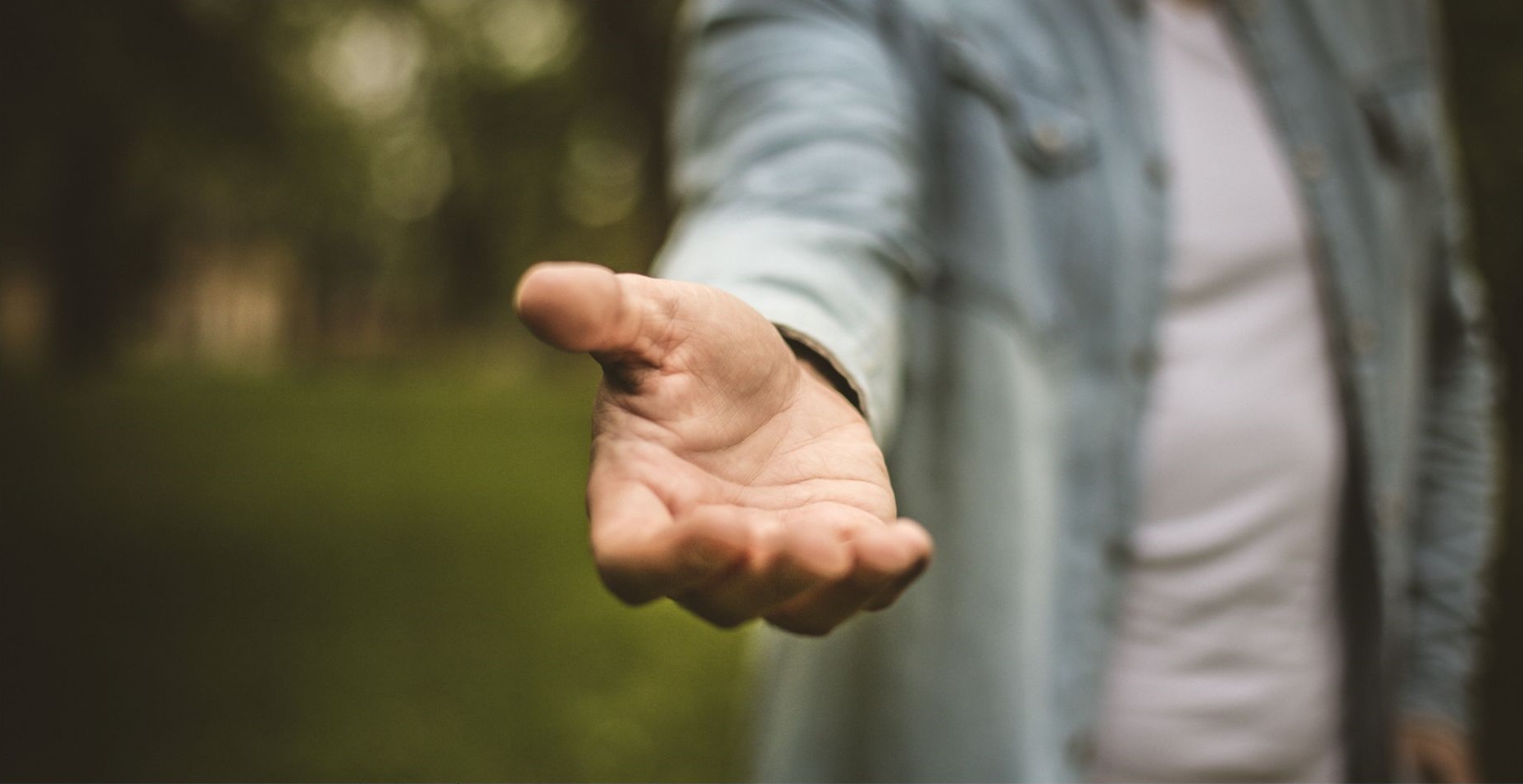 A man holding his hand out - support and help