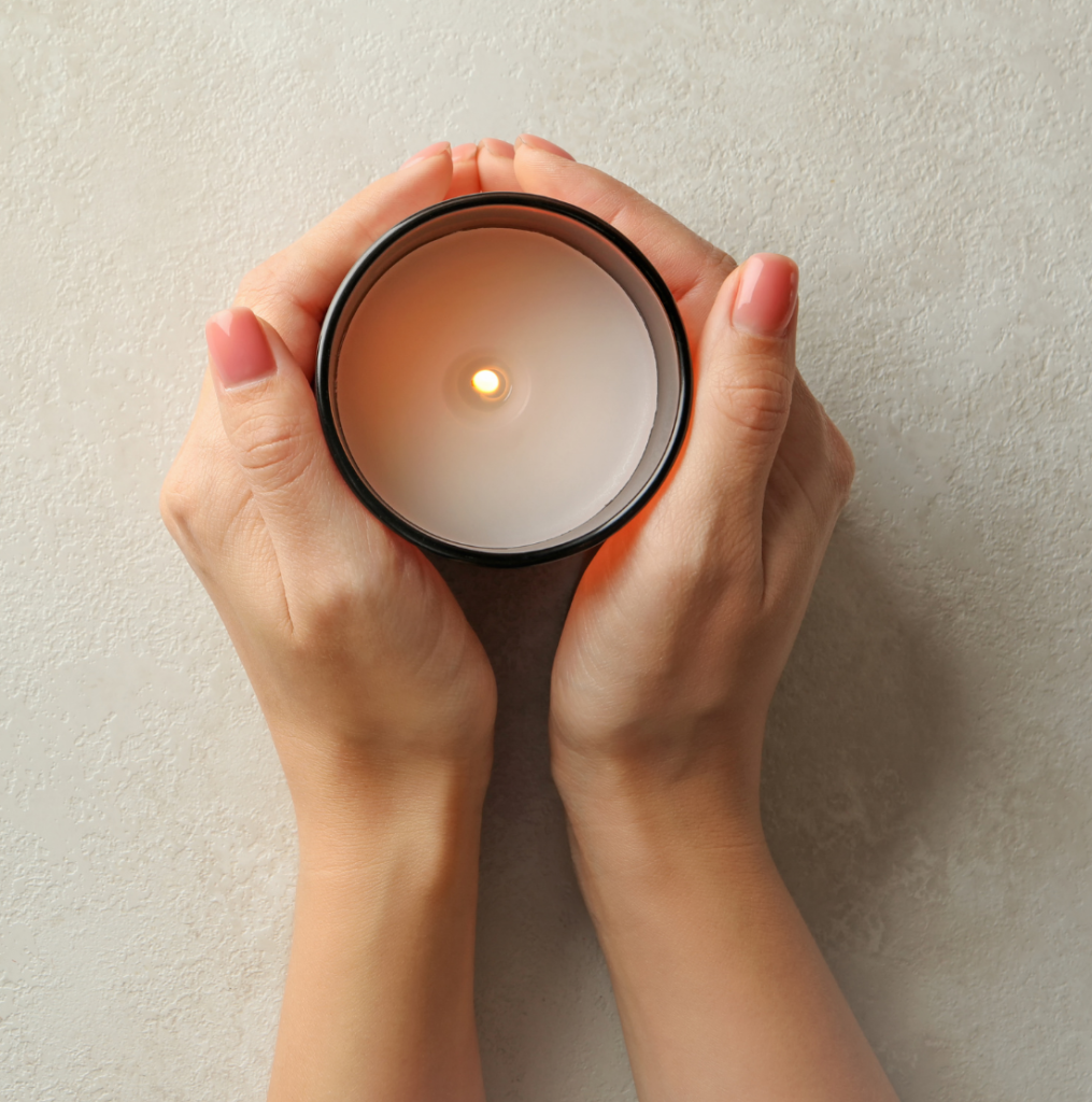 Hands holding a candle - signifying hope